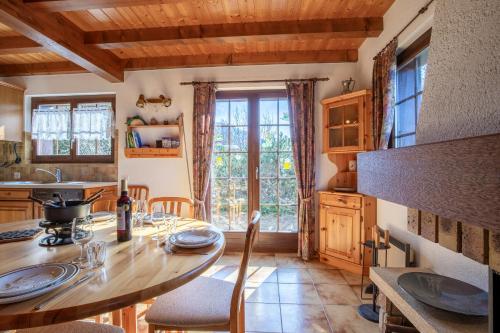 a kitchen with a wooden table and a large window at Chalet Hibou MOUNTAIN & QUIET chalet 6 pers in Veysonnaz