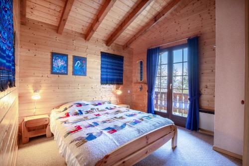 a bedroom with a bed in a wooden room at Chalet Hibou MOUNTAIN & QUIET chalet 6 pers in Veysonnaz