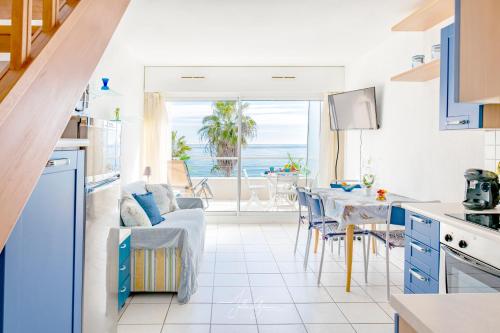 - une cuisine et une salle à manger avec vue sur l'océan dans l'établissement Acquamarina Duplex dernier étage, à Villeneuve-Loubet