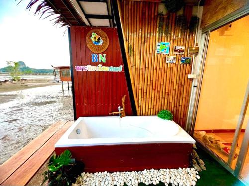 a bathroom with a red and white bath tub at Bnเกาะลิบงโฮมสเตย์ in Ko Libong