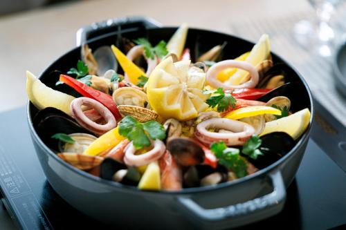 a pan filled with vegetables on top of a table at Namba Oriental Hotel in Osaka