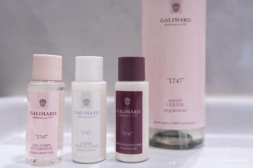 a group of four bottles of cosmetics on a table at Aparthotel AMMI Nice Lafayette in Nice