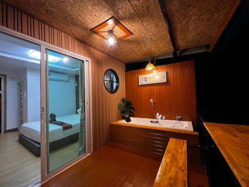 a bathroom with a sink and a bed in a room at Bnเกาะลิบงโฮมสเตย์ in Ko Libong