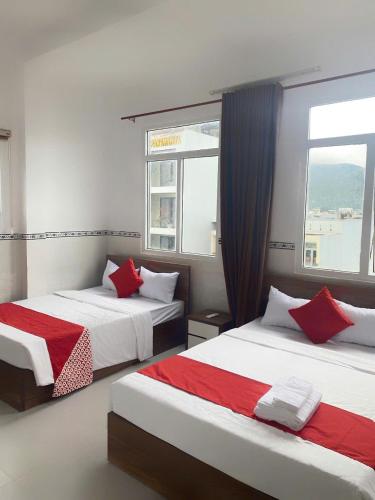 a bedroom with two beds and a window at LUXURY Motel in Da Nang