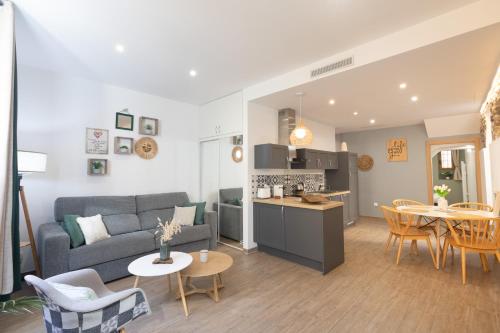 a living room and kitchen with a couch and a table at Le Mattoni 2 in Menton