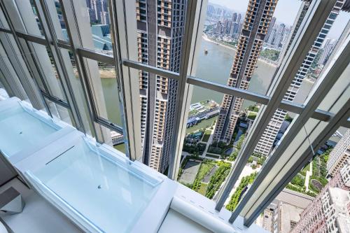a view of a city from a high rise building at 重庆Indition英迪逊高空酒店 解放碑来福士店 in Chongqing