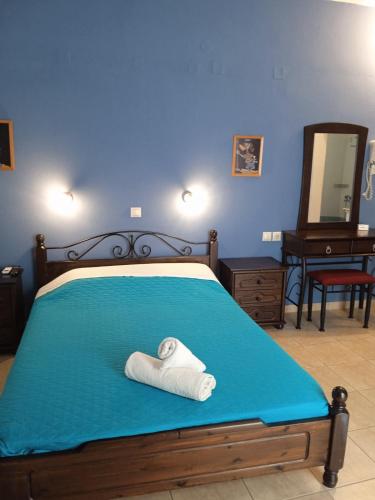 a bedroom with a bed with a towel on it at Kouvaras Apartments in Kýthira