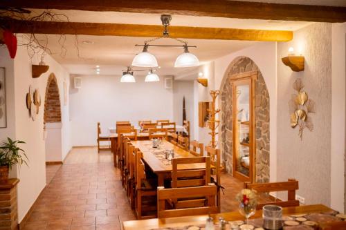 a dining room with a long table and wooden chairs at Hotel Na Pekárně in Sušice