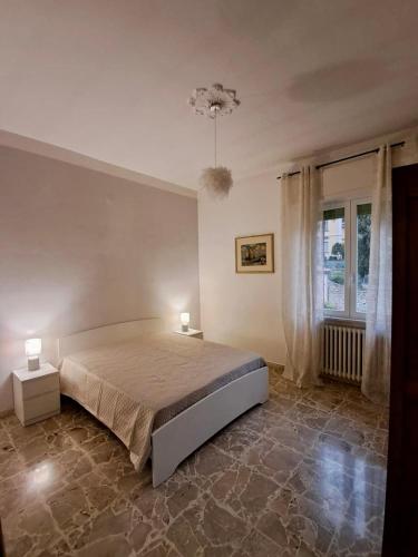 a bedroom with a bed and two lamps in it at Alloggio in antico borgo tra mare e montagna in Pieve di Teco