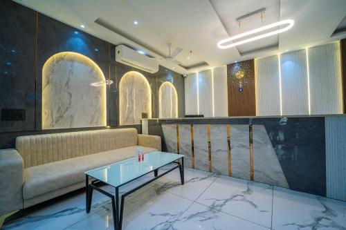 a living room with a couch and a table at Treebo Gemstone in New Delhi