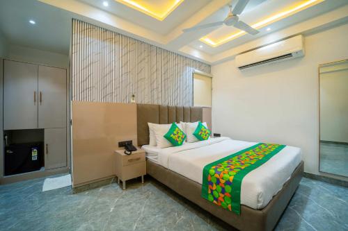 a bedroom with a bed and a television in it at Treebo Gemstone in New Delhi