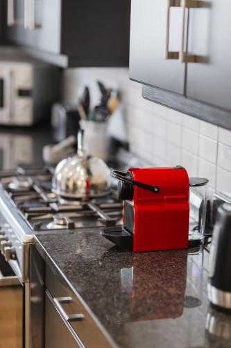 a red container sitting on top of a kitchen counter at Cherry Blossom in Ceres