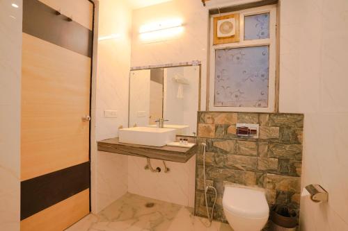 a bathroom with a toilet and a sink at Chirping Hills Resort,Bhimtal in Bhīm Tāl