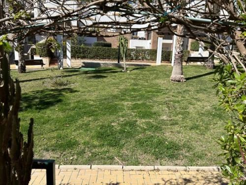 a park with trees and benches in the grass at AL ANDALUS-THALASSA Premium in Vera