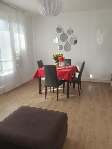 une salle à manger avec une table et des chaises rouges dans l'établissement Le nouveau monde, à Bayeux