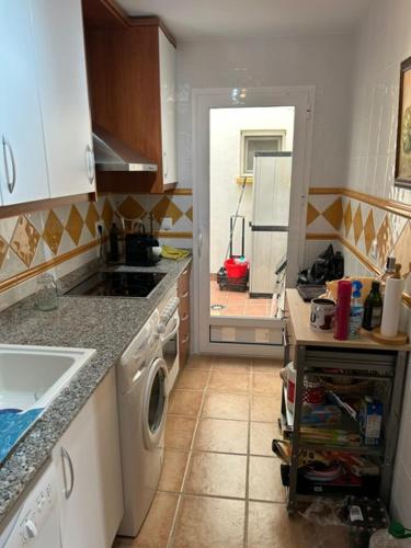 a kitchen with a sink and a washer and dryer at AL ANDALUS-THALASSA Premium in Vera