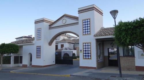 a white building with an archway on a street at AL ANDALUS-THALASSA Premium in Vera