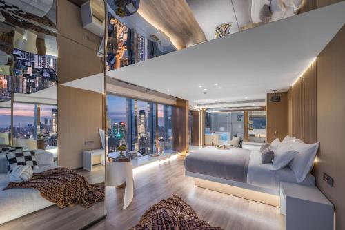 a bedroom with a large bed and large windows at 重庆Indition英迪逊高空酒店 解放碑来福士店 in Chongqing
