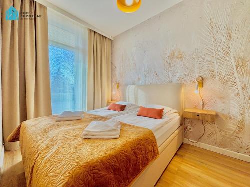 En eller flere senge i et værelse på Pod Brzozami Apartamenty Ku Morzu