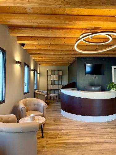 a lobby with a reception desk and a tv at Ida Boutique Hotel in Casa Marcolin