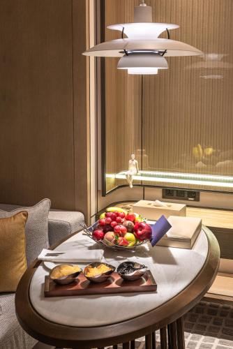 a tray of fruit on a table in a room at Narcissus The Royal Hotel in Riyadh