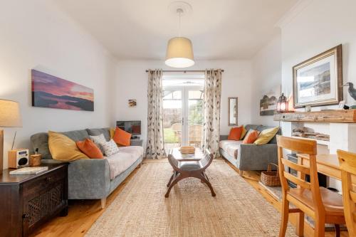 a living room with a couch and a table at Heather Cottage, 2 bedroom in Comrie in Comrie