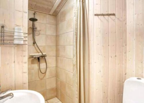 a bathroom with a shower and a sink at Summerhouse On The Beach And With Ocean View in Yderby