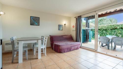 un salon avec une table, des chaises et un canapé dans l'établissement Samaria Village N08 - 2P4, à Agde