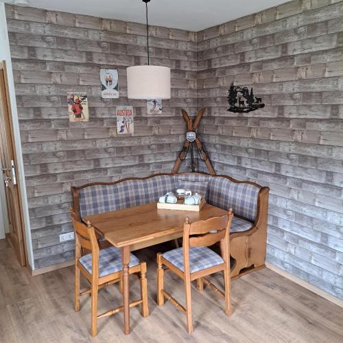 a dining room with a wooden table and chairs at Haus am Schloss in Bleiburg