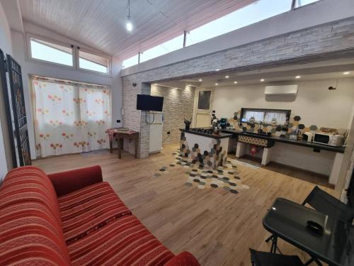 a living room with a couch and a video game at Openspace A Villa Serroni Mazara in Mazara del Vallo