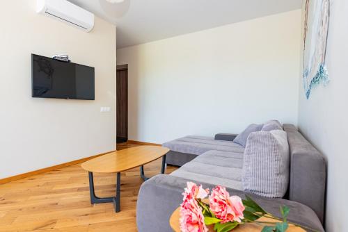 a living room with a couch and a table at Bangų g. Apartamentai in Klaipėda