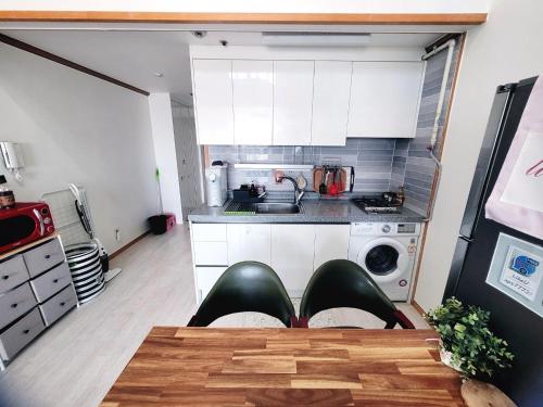 a kitchen with a person laying on the table at Like U Residence in Goyang