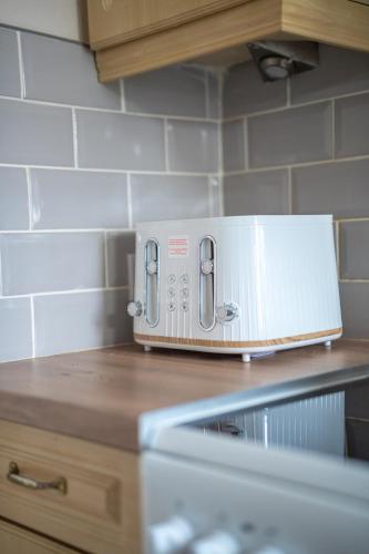 a toaster oven sitting on top of a kitchen counter at Richard Gardens in Bathgate