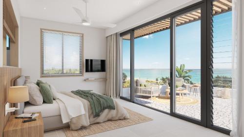 a bedroom with a bed and a view of the ocean at Le Dalblair by Horizon Holidays in Pointe d'Esny