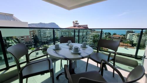 a table and chairs on a balcony with a view at Elite Luxury Suite - City 3 in Alanya