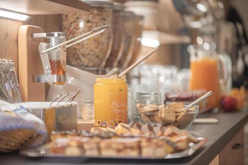 a table with a plate of food and orange juice at Apartments Hochbrunn - Pension Brunner in San Giuseppe in Anterselva