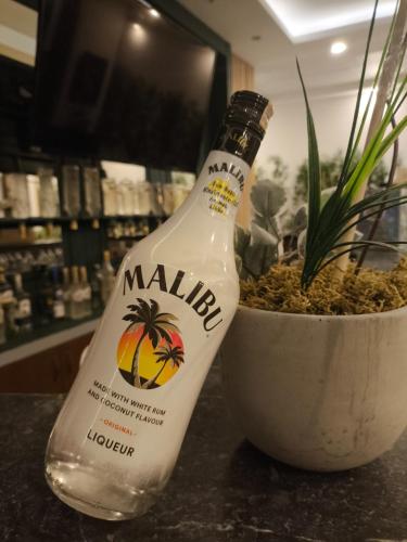 a bottle of milk sitting next to a plant at Akman City Hotel in Kusadası