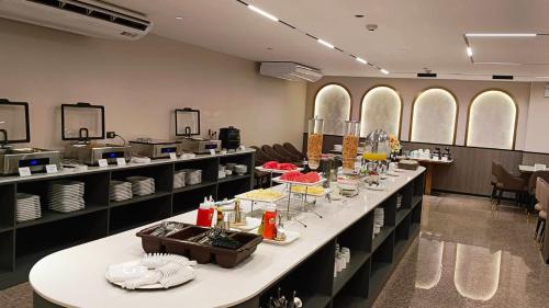 a room with a long table with dishes on it at Miloft Suvarnabhumi Airport Hotel in Bangkok