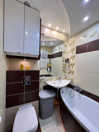 a bathroom with a toilet and a sink at Gdynia City Stay in Gdynia