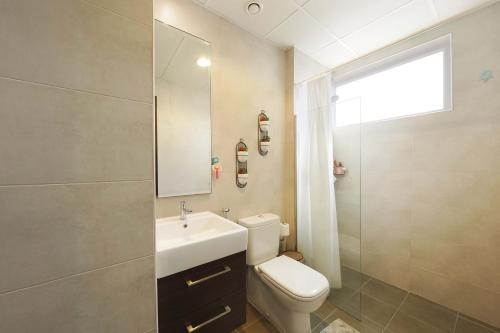 a bathroom with a toilet and a sink and a shower at Modern Villa Stay Private & Secure Damac Hills 2 in Dubai