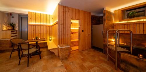 a room with a desk and a table and a chair at Hotel Praha in Hřensko