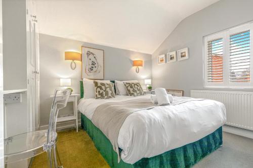 a bedroom with a large bed and a glass table at River cabin & Mills Cottage in Henley on Thames