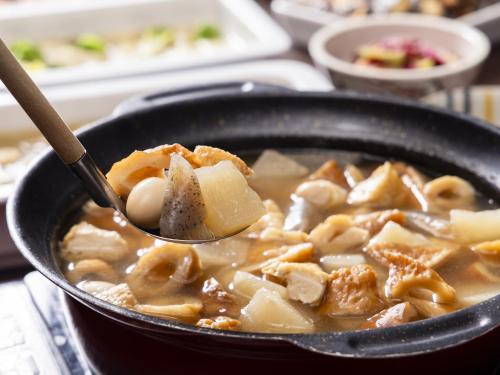 a bowl of soup with a spoon in it at KOKO HOTEL Himeji Castle in Himeji