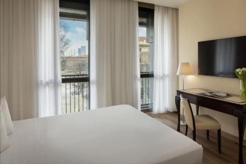 Postel nebo postele na pokoji v ubytování UNA Hotels Cusani Milano