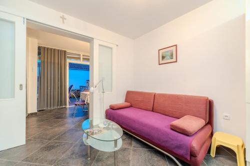 a living room with a couch and a glass table at Boba lovely apartment close to Zrce beach in Gajac