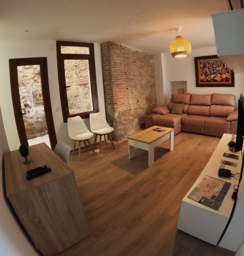 a living room with a couch and a table at Alojamiento Wadi Dar Al-Farah "La Casa de la Alegría de Guadix" in Guadix