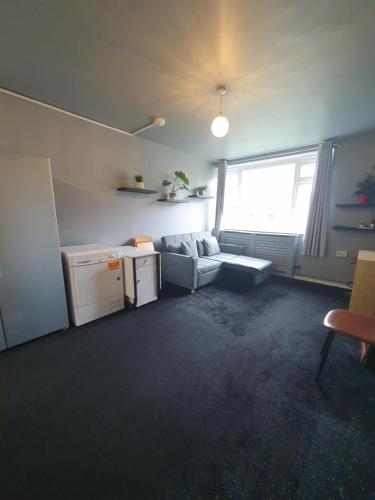 a living room with a couch and a window at A home in the city in London