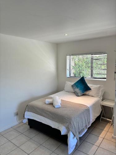 a bedroom with a large bed with a window at 120 on Lyme in St Francis Bay