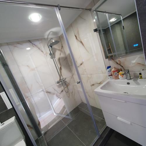 a bathroom with a shower and a sink at Balkan Tower Deluxe Ultra in Gabrovo