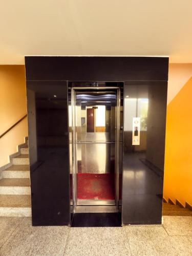 an elevator in a building with a red carpet at Hotel Royal Palm - A Budget Hotel in Udaipur in Udaipur